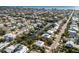 Expansive aerial view shows waterfront properties, canals, and tropical foliage of a lively coastal community at 527 Magnolia Ave, Anna Maria, FL 34216