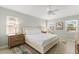 Cozy bedroom with bright windows, neutral colors, and a ceiling fan at 527 Magnolia Ave, Anna Maria, FL 34216