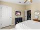 Cozy bedroom featuring a TV, modern ceiling fan, and access to another room at 527 Magnolia Ave, Anna Maria, FL 34216