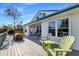 Spacious outdoor deck with a dining area, lounge chairs, and beautiful views of the surrounding landscape at 527 Magnolia Ave, Anna Maria, FL 34216
