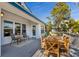 Outdoor deck with a wooden dining table, a tranquil outdoor seating arrangement, and great natural light at 527 Magnolia Ave, Anna Maria, FL 34216