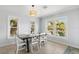 Inviting dining room with a large window view and a modern light fixture at 527 Magnolia Ave, Anna Maria, FL 34216