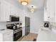 Kitchen featuring stainless steel appliances and decorative pendant lighting at 527 Magnolia Ave, Anna Maria, FL 34216