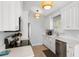Kitchen with stainless steel appliances, white cabinets, and quartz countertops at 527 Magnolia Ave, Anna Maria, FL 34216