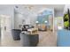 Bright, expansive living room boasting high ceilings, neutral tones, comfortable seating, and lots of natural light at 527 Magnolia Ave, Anna Maria, FL 34216
