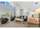 Bright living room with high ceilings, coastal decor, and beautiful natural light throughout at 527 Magnolia Ave, Anna Maria, FL 34216