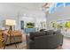 Bright, expansive living room boasting high ceilings, neutral tones, comfortable seating, and lots of natural light at 527 Magnolia Ave, Anna Maria, FL 34216
