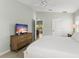 Spacious main bedroom with a beautiful view, TV, and bright windows at 527 Magnolia Ave, Anna Maria, FL 34216