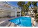 Beautiful pool with lounge chairs and well maintained pavers at 527 Magnolia Ave, Anna Maria, FL 34216