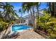 Inviting pool with a spacious deck surrounded by lush tropical landscaping, perfect for relaxation at 527 Magnolia Ave, Anna Maria, FL 34216