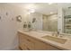 Elegant bathroom featuring double sinks, a huge mirror, and a luxurious glass shower at 535 Sanctuary Dr # B604, Longboat Key, FL 34228