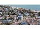Aerial view of a luxurious modern home with a pool, situated near a sandy beach and the ocean at 597 Buttonwood Dr, Longboat Key, FL 34228