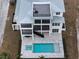 Aerial view showcasing the backyard pool and roof deck of this modern, stylish home at 597 Buttonwood Dr, Longboat Key, FL 34228