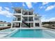 Stunning backyard featuring a large pool, modern patio, and outdoor dining area at 597 Buttonwood Dr, Longboat Key, FL 34228