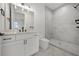 Bright bathroom features a marble tiled walk-in shower, modern vanity, black fixtures and tiled floor at 597 Buttonwood Dr, Longboat Key, FL 34228