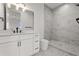 Stylish bathroom featuring a sleek vanity, black hardware, tiled floor and luxurious walk-in shower with marble tiling at 597 Buttonwood Dr, Longboat Key, FL 34228