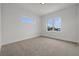 Bright bedroom with plush carpet and large windows offering pleasant views at 597 Buttonwood Dr, Longboat Key, FL 34228