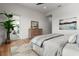 Spacious bedroom with dresser and hardwood floors at 597 Buttonwood Dr, Longboat Key, FL 34228