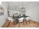 Bright dining room with a modern dining table, chairs, and view of the kitchen at 597 Buttonwood Dr, Longboat Key, FL 34228