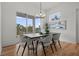 Bright dining room with modern table, chairs, and large windows overlooking the outdoors at 597 Buttonwood Dr, Longboat Key, FL 34228