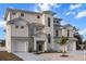 New construction three-story home with a two-car garage, manicured landscaping, and a contemporary architectural style at 597 Buttonwood Dr, Longboat Key, FL 34228