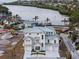 New home featuring a multi-car garage, modern architecture, and a serene waterfront location at 597 Buttonwood Dr, Longboat Key, FL 34228
