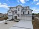 Contemporary home with a three-car garage, clean landscaping, and modern design at 597 Buttonwood Dr, Longboat Key, FL 34228