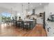 Open concept kitchen featuring a large island with bar seating, stainless steel appliances, and an adjacent dining area at 597 Buttonwood Dr, Longboat Key, FL 34228