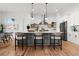 Bright kitchen with a large island, stainless steel appliances, pendant lighting, and hardwood floors at 597 Buttonwood Dr, Longboat Key, FL 34228
