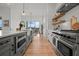 Modern kitchen featuring stainless steel appliances, gray cabinets, and a breakfast nook at 597 Buttonwood Dr, Longboat Key, FL 34228