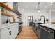 Modern kitchen featuring stainless steel appliances and white cabinets and marble countertops at 597 Buttonwood Dr, Longboat Key, FL 34228