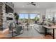 Comfortable living room featuring a stone fireplace, hardwood floors, and a scenic view at 597 Buttonwood Dr, Longboat Key, FL 34228