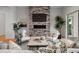 Stylish living room with a stone fireplace, modern furniture, hardwood floors, and a cozy ambiance for relaxing at 597 Buttonwood Dr, Longboat Key, FL 34228
