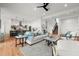 Bright, open-concept living room with hardwood floors and views of the modern kitchen at 597 Buttonwood Dr, Longboat Key, FL 34228