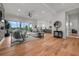 Spacious living area featuring hardwood floors, contemporary furniture, and an open floor plan with great natural lighting at 597 Buttonwood Dr, Longboat Key, FL 34228