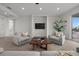 Bright living room featuring cozy seating, neutral walls, recessed lighting, and balcony access with scenic neighborhood views at 597 Buttonwood Dr, Longboat Key, FL 34228