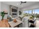 Stylish living room with stone fireplace, plush seating, and sliding doors to a private balcony at 597 Buttonwood Dr, Longboat Key, FL 34228