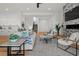 Bright living room with open floor plan, comfortable sofa, and access to staircase at 597 Buttonwood Dr, Longboat Key, FL 34228