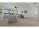 Bright living room with neutral tones, plush seating, ceiling fan, and sliding doors to a balcony offering serene views at 597 Buttonwood Dr, Longboat Key, FL 34228