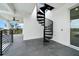 Stylish black spiral staircase leading to the rooftop deck, a unique design element at 597 Buttonwood Dr, Longboat Key, FL 34228