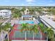 Aerial view of community features pool, tennis courts, well-maintained landscaping, and clubhouse at 5970 Midnight Pass Rd # 177, Sarasota, FL 34242