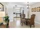 Inviting dining area with a glass table, wicker chairs, and views into the kitchen at 5970 Midnight Pass Rd # 177, Sarasota, FL 34242
