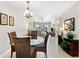 Bright dining area leading to a living room with comfortable seating and scenic water views at 5970 Midnight Pass Rd # 177, Sarasota, FL 34242