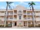 Exterior building view featuring well-maintained landscaping, beautiful balconies, and detailed architecture at 5970 Midnight Pass Rd # 177, Sarasota, FL 34242