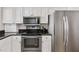This kitchen features white cabinets, stainless steel appliances, and a dark countertop at 5970 Midnight Pass Rd # 177, Sarasota, FL 34242