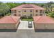 Exterior view of the condo buildings with garages and lush landscaping at 602 Casa Del Lago Way # 602, Venice, FL 34292