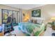 Bright bedroom featuring a work area and sliding glass doors to a balcony with golf course view at 6120 43Rd W St # 103B, Bradenton, FL 34210