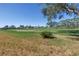 Beautiful view of the golf course showcasing a sand trap and mature trees under a clear blue sky at 6120 43Rd W St # 103B, Bradenton, FL 34210