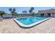Community pool featuring clear blue water, plenty of lounge chairs, and beautiful landscaping at 6120 43Rd W St # 103B, Bradenton, FL 34210