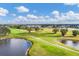 Picturesque aerial view showcasing the sprawling golf course, serene ponds, and beautifully maintained landscaping at 6314 Stone River Rd # 6314, Bradenton, FL 34203